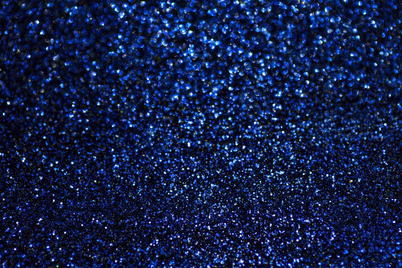 Blurred shiny navy blue background with sparkling lights.